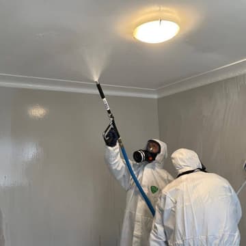 Professional meth cleanup technician in protective gear decontaminating Auckland property